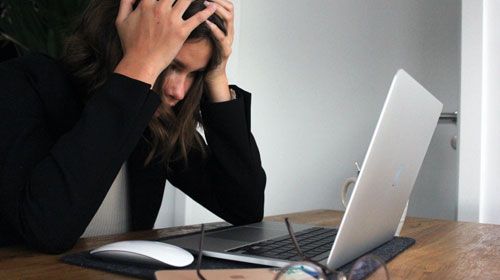 Stressed candidate sitting an online examination