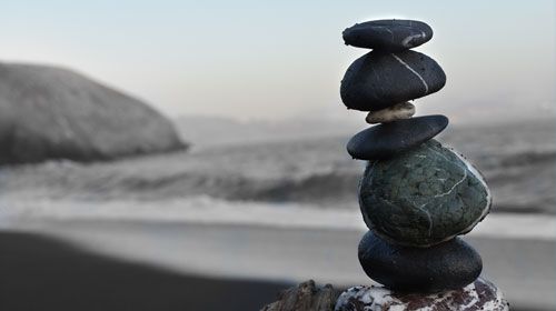 Stones balancing on top of one another on a beach