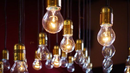 Many lit lightbulbs representing constant technological innovation