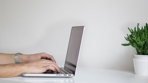 Man taking an online exam at home with TestReach during Covid-19