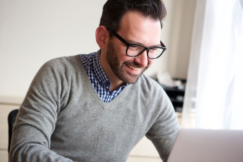 businessman-working-with-laptop-computer-at-home-during-online-exam