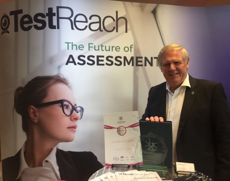 Captain John Lloyd, CEO of Nautical Institute on TestReach Stand with EAssessment Award Trophy