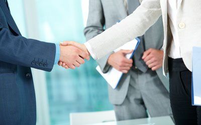 People doing handshake at awarding organisation